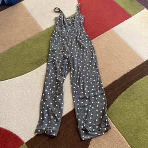 Sleeveless green polkadot jumpsuit with front key-hole cut out